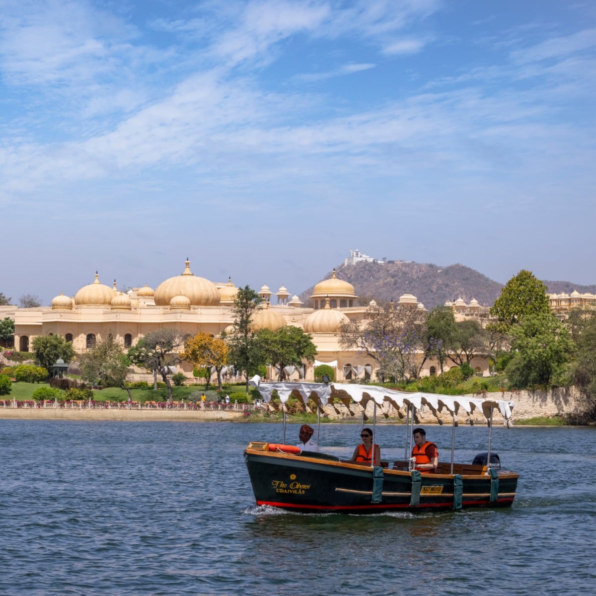 A boat on Lake Pichola with the City Palace behind, Udaipur