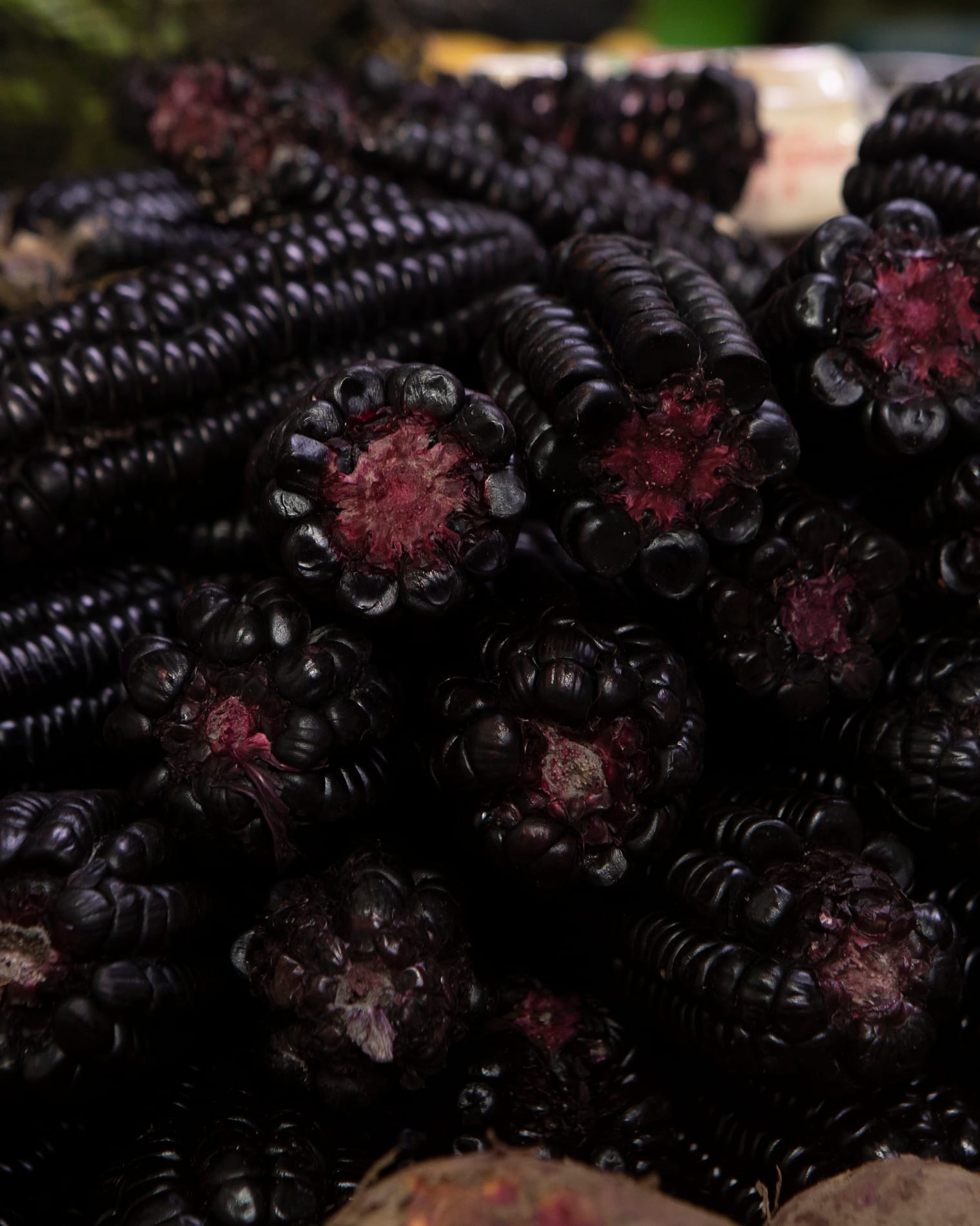 Purple corn piled high at a Lima market